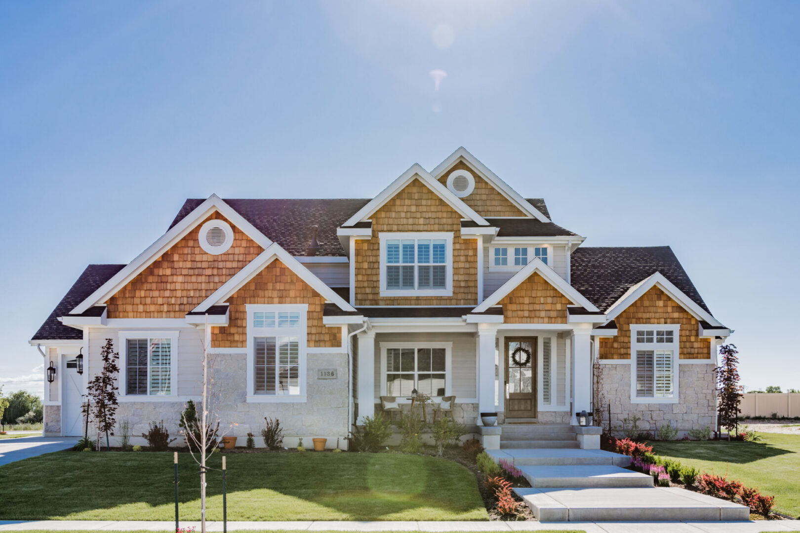 Large modern expensive home Upscale modern home in new development, meticulously landscaped, large windows